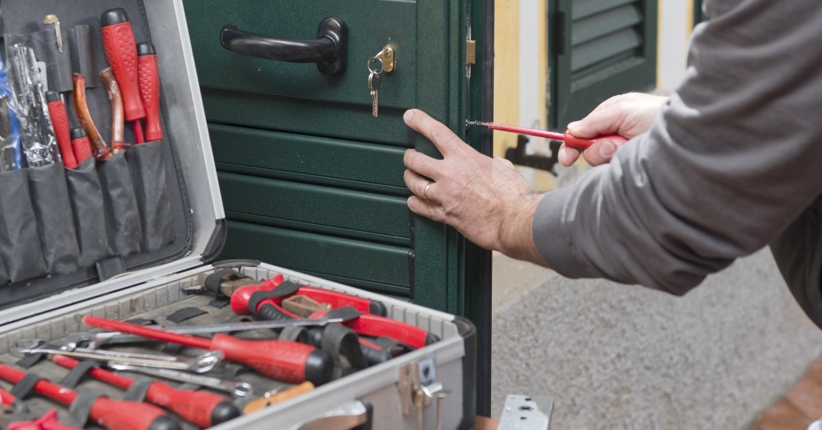 Image of a locksmith working at a home.